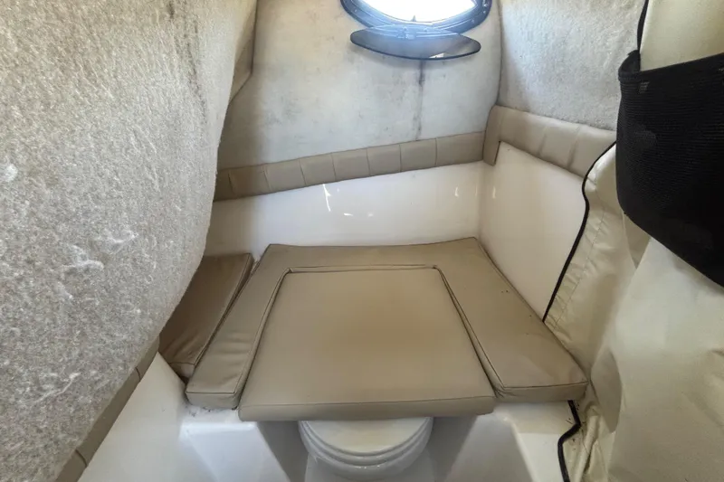 Slide: The Image of 2016 Sea Fox 249 Avenger cabin interior with beige cushions and small window. - 43