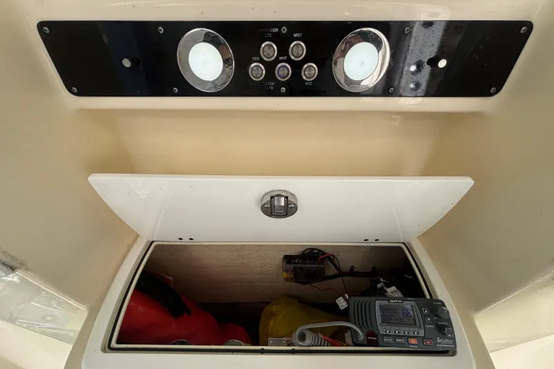 Slide: The Image of Control panel and storage compartment on a 2016 Sea Fox 249 Avenger boat. - 32