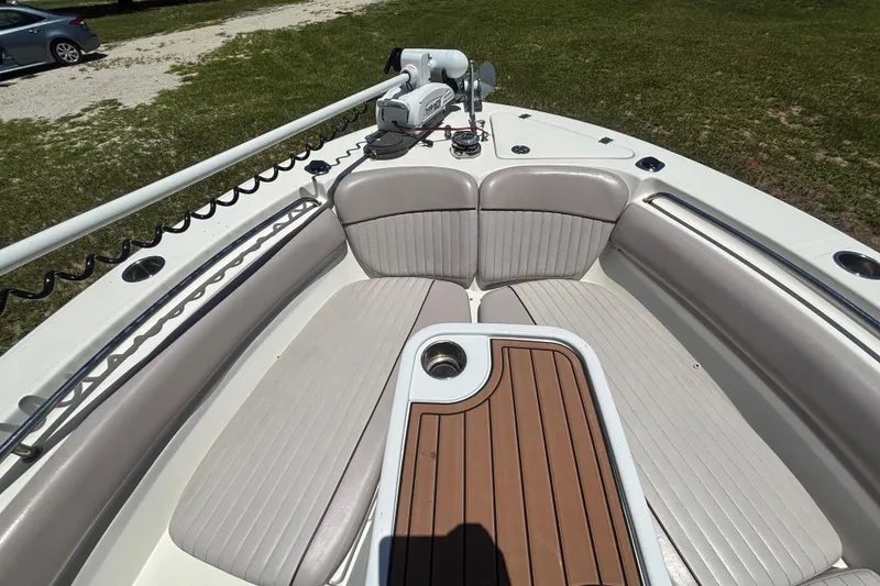 Slide: The Image of 2016 Sea Fox 249 Avenger boat interior with cushioned seating and wooden deck. - 52