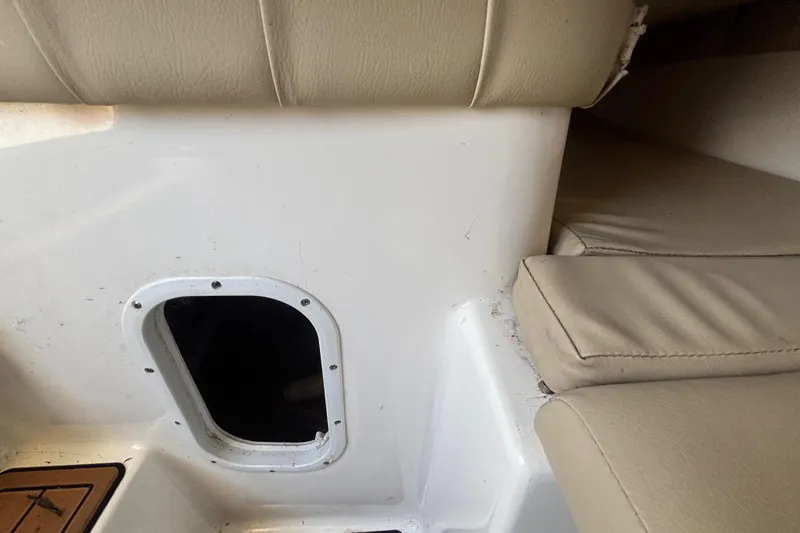 Slide: The Image of Interior view of a 2016 Sea Fox 249 Avenger boat, featuring seating and storage compartment. - 46