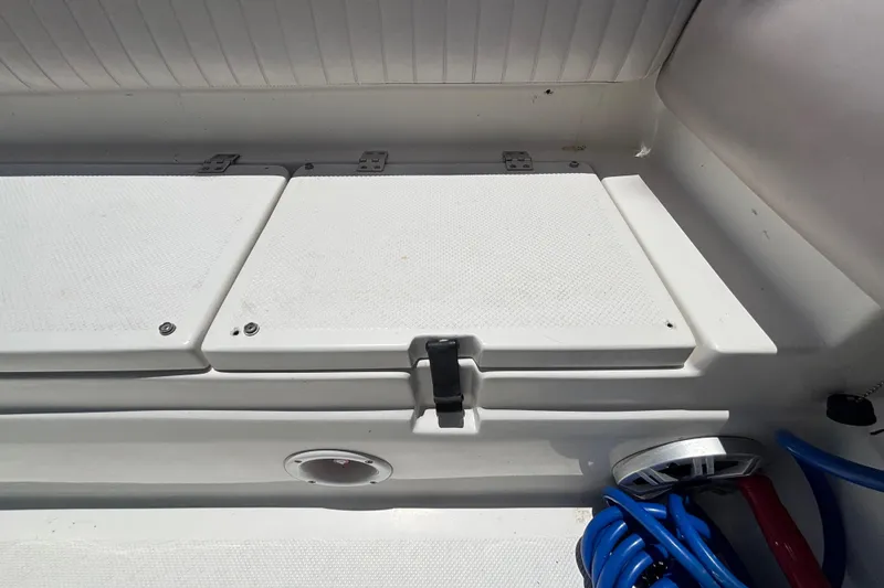Slide: The Image of Storage compartment on a 2016 Sea Fox 249 Avenger boat, featuring a secure latch. - 78