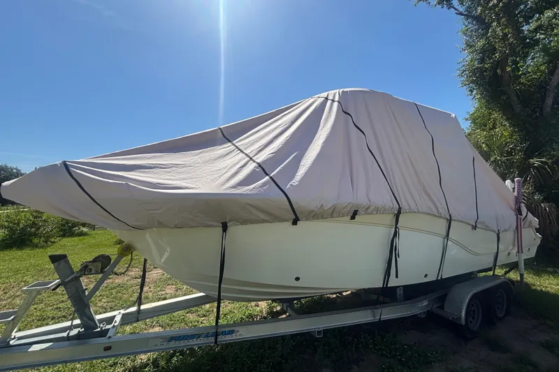 Slide: The Image of 2016 Sea Fox 249 Avenger boat covered on trailer under clear blue sky. - 88