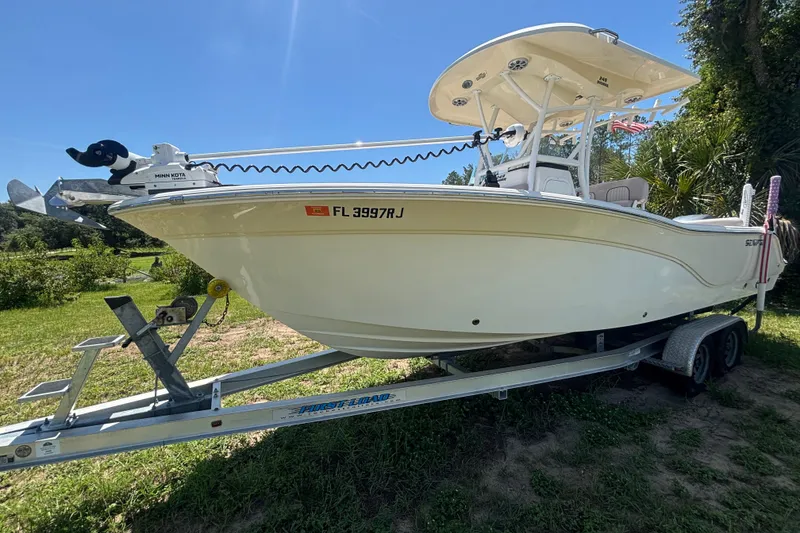 Slide: The Image of 2016 Sea Fox 249 Avenger boat on trailer, sunny outdoor setting. - 11