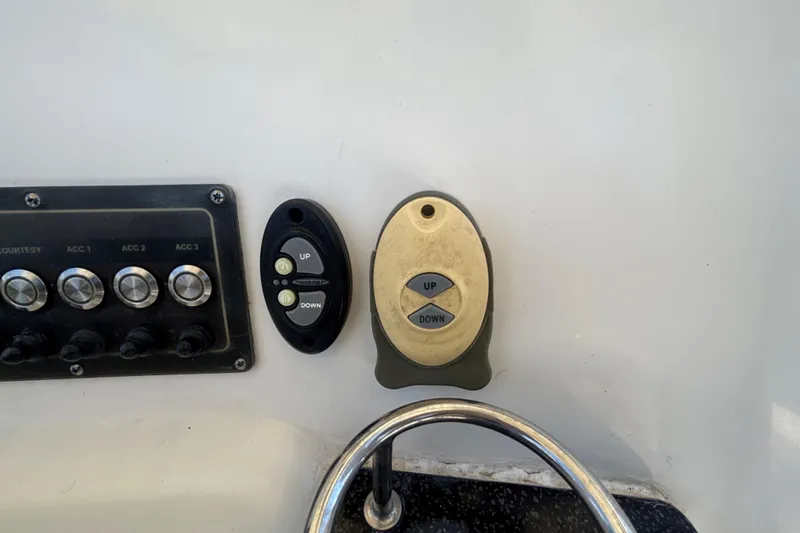 Slide: The Image of Control panel and switches on a 2016 Sea Fox 249 Avenger boat dashboard. - 24