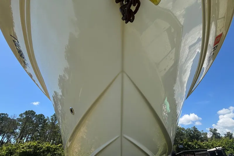 Slide: The Image of 2016 Sea Fox 249 Avenger boat hull, parked outdoors under a clear blue sky. - 13