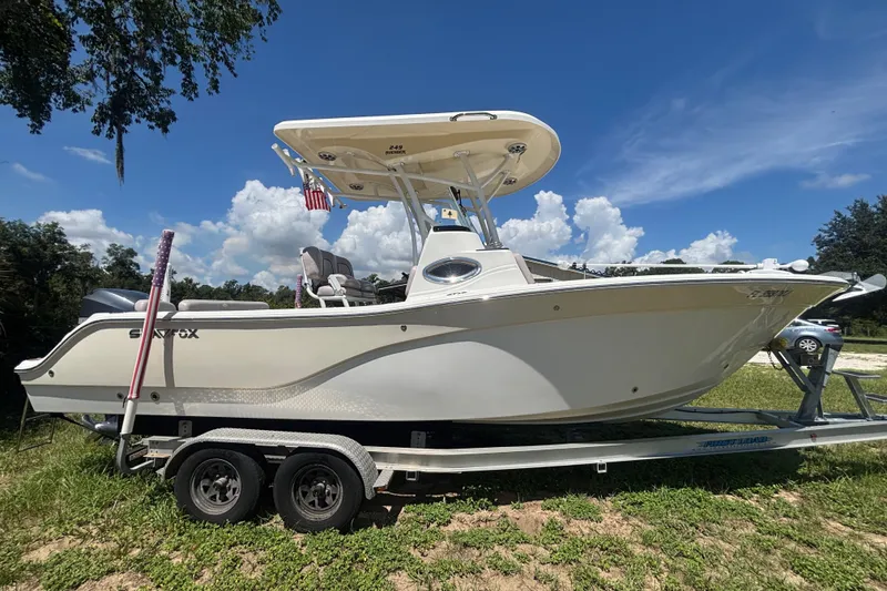 Slide: The Image of 2016 Sea Fox 249 Avenger boat on trailer under clear blue sky. - 1