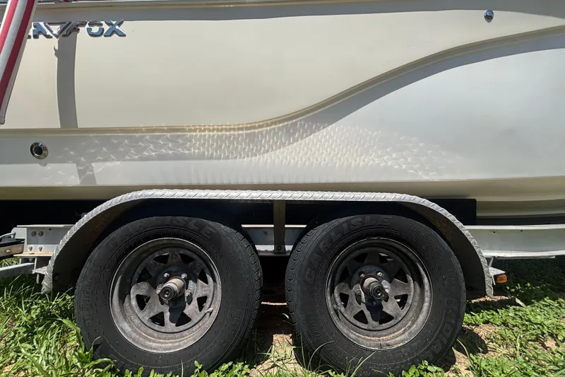 Slide: The Image of Trailer with dual wheels carrying a 2016 Sea Fox 249 Avenger boat. - 85
