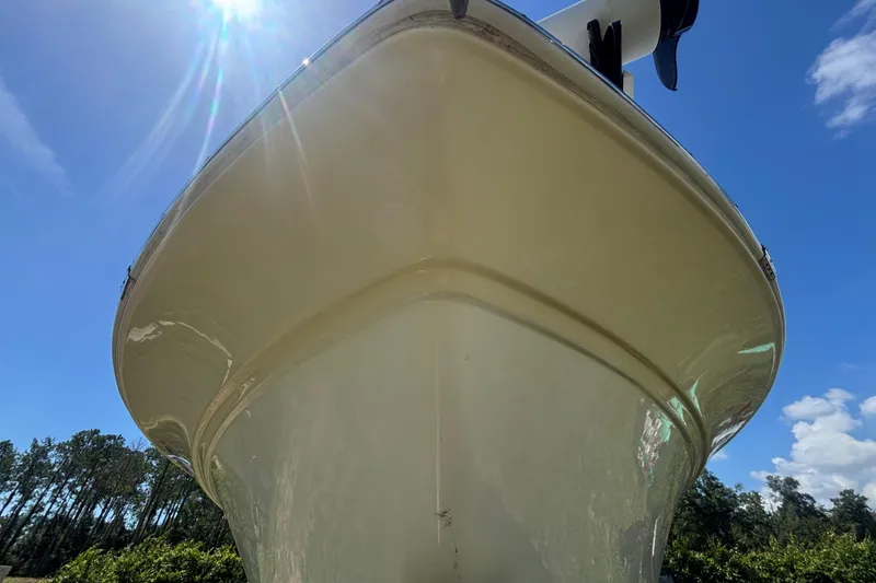 Slide: The Image of 2016 Sea Fox 249 Avenger boat under bright sun, showcasing sleek hull design. - 12
