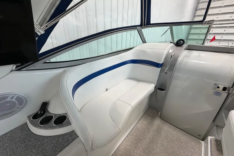 Slide: The Image of Interior of a 2004 Formula 34 Performance Cruiser with white seating and blue accents. - 13