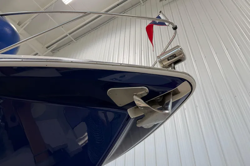 Slide: The Image of 2004 Formula 34 Performance Cruiser bow with anchor and flag in indoor setting. - 4