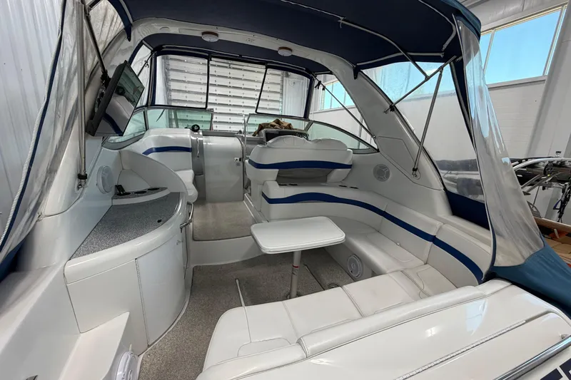 Slide: The Image of 2004 Formula 34 Performance Cruiser interior with seating, table, and canopy in a showroom. - 7