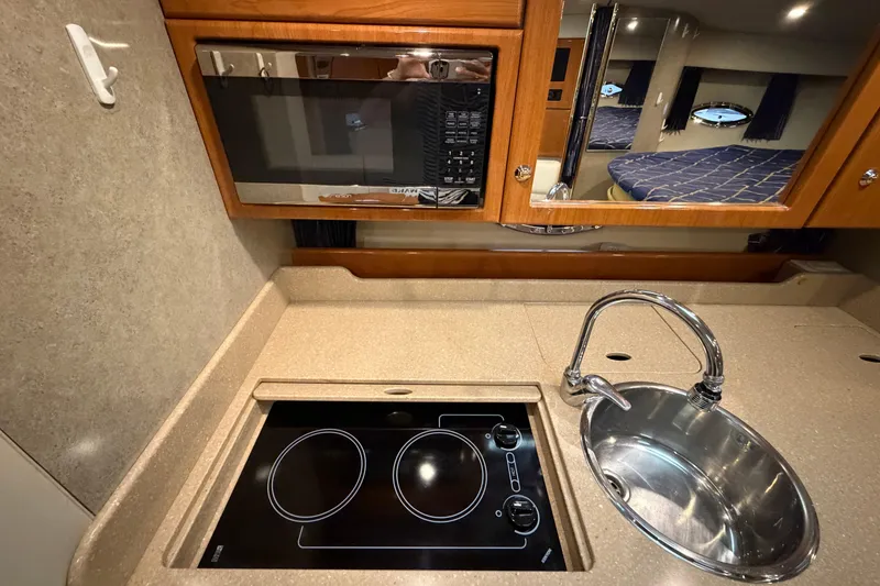 Slide: The Image of 2004 Formula 34 Performance Cruiser kitchen with stove, sink, and microwave. - 25