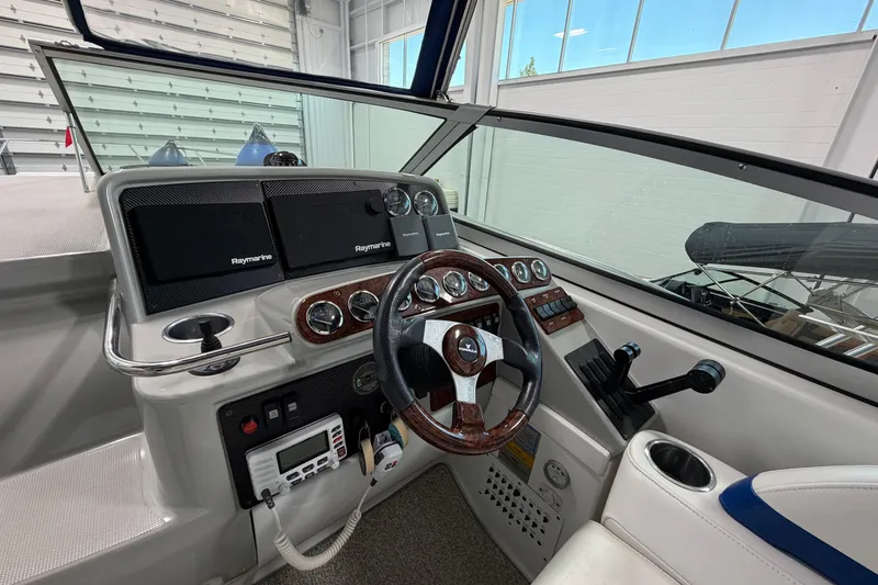 Slide: The Image of 2004 Formula 34 Performance Cruiser helm with Raymarine electronics and wood-accented steering wheel. - 15