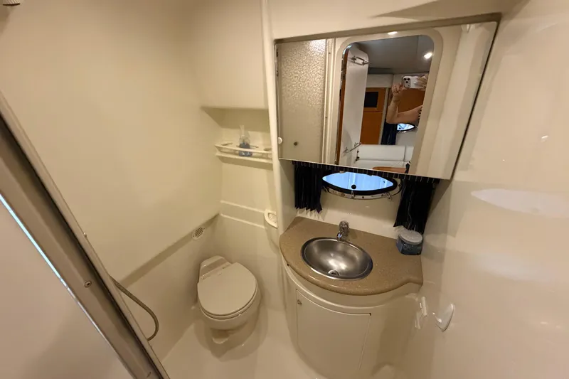Slide: The Image of 2004 Formula 34 Performance Cruiser bathroom with sink, toilet, and mirror. - 28
