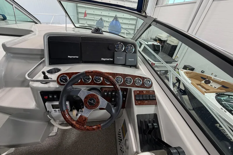Slide: The Image of 2004 Formula 34 Performance Cruiser helm with Raymarine electronics and wood-accented steering wheel. - 16
