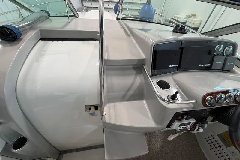 Slide: The Image of 2004 Formula 34 Performance Cruiser helm with Raymarine electronics and sleek dashboard design. - 18
