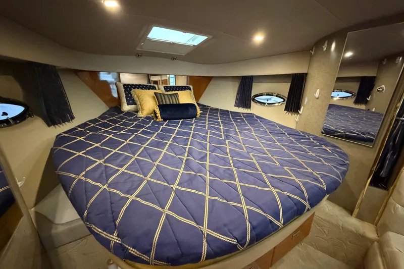 Slide: The Image of Interior cabin of a 2004 Formula 34 Performance Cruiser with a cozy bed setup. - 27