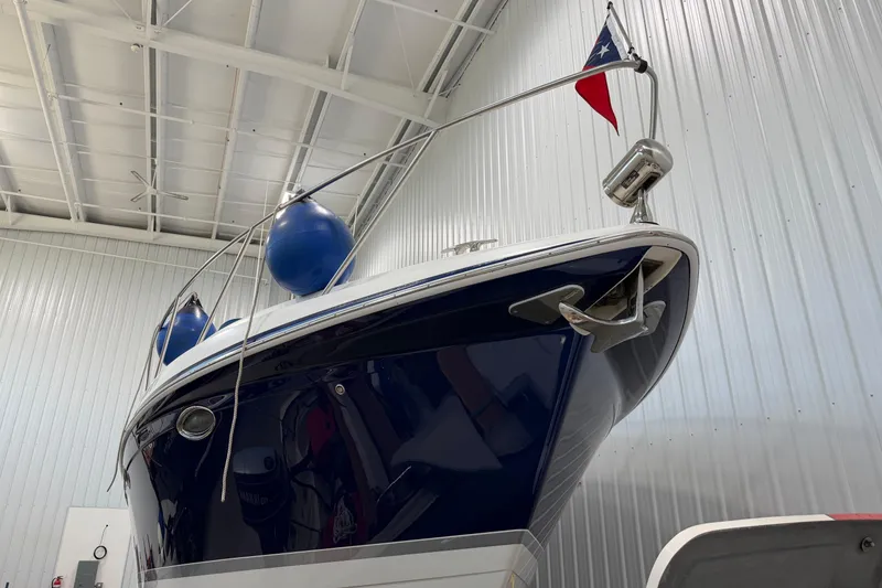 Slide: The Image of 2004 Formula 34 Performance Cruiser in storage, featuring sleek design and nautical flag. - 3