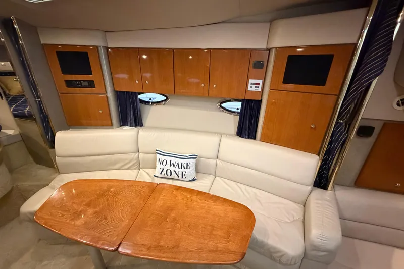 Slide: The Image of Interior of 2004 Formula 34 Performance Cruiser with beige seating and wooden cabinetry. - 21