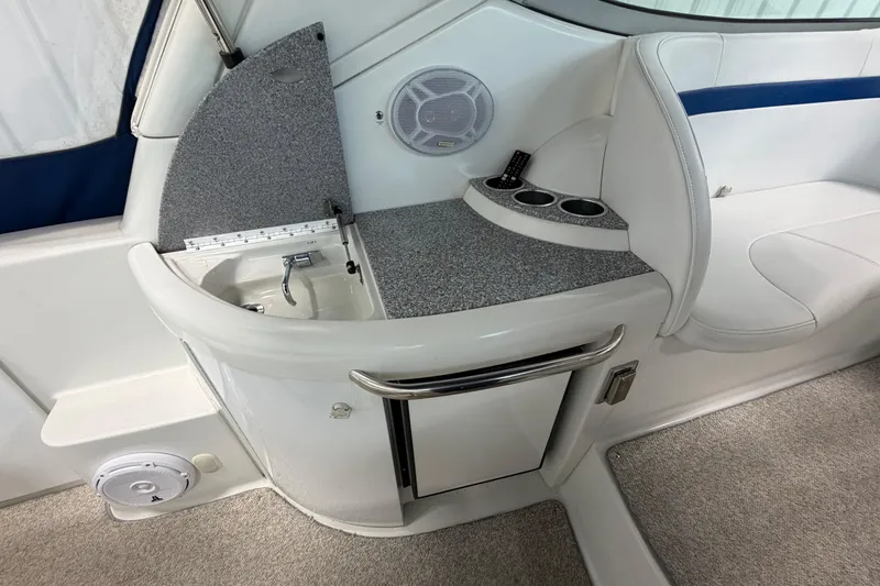 Slide: The Image of 2004 Formula 34 Performance Cruiser interior with sink, seating, and cup holders. - 11