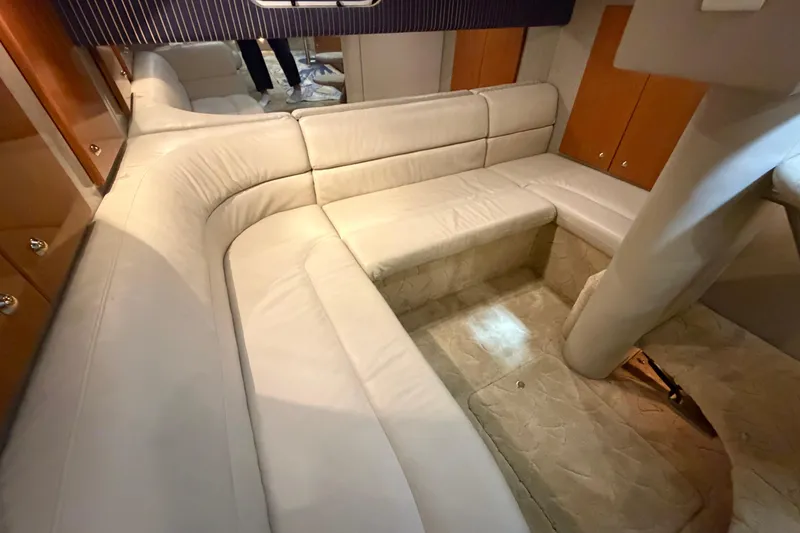 Slide: The Image of Luxurious interior of a 2004 Formula 34 Performance Cruiser with plush seating and wood accents. - 23