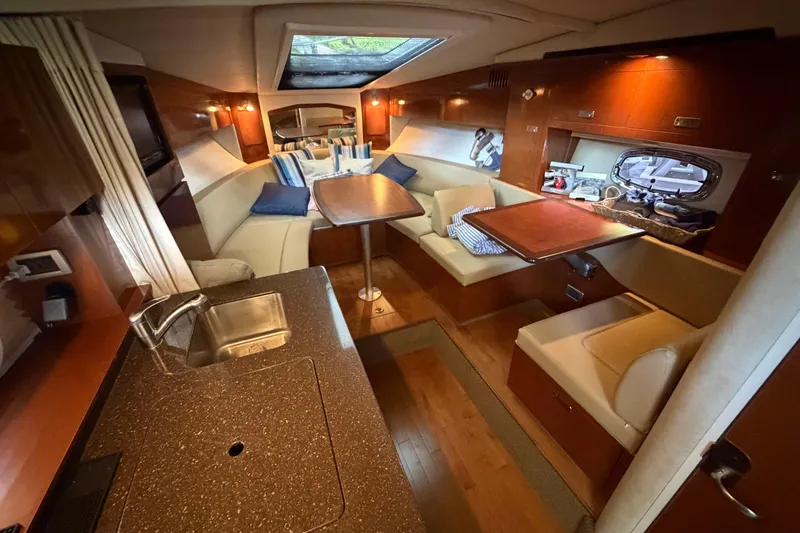 Slide: The Image of Luxurious interior of a 2012 Sea Ray Sundancer 310 yacht with cozy seating and kitchenette. - 23