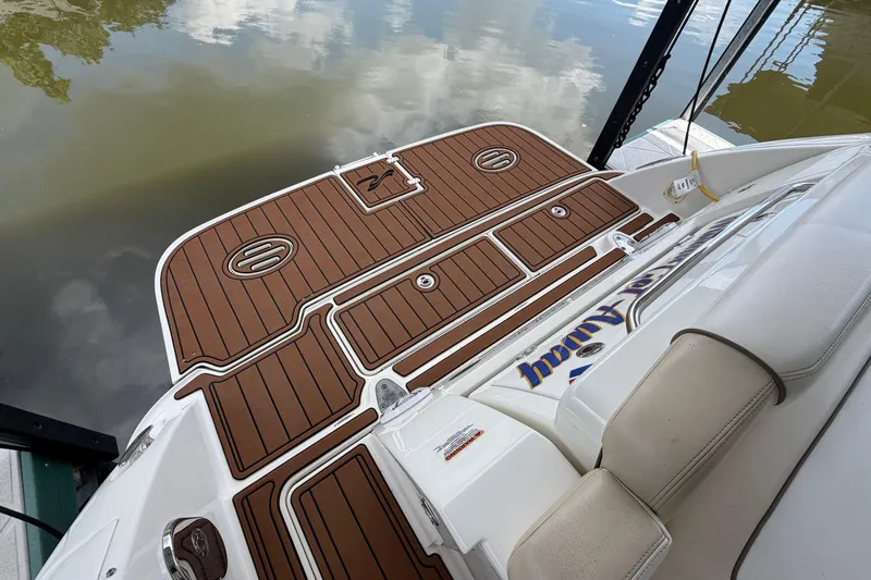 Slide: The Image of 2012 Sea Ray Sundancer 310 swim platform with teak-style decking, reflecting water surface. - 5
