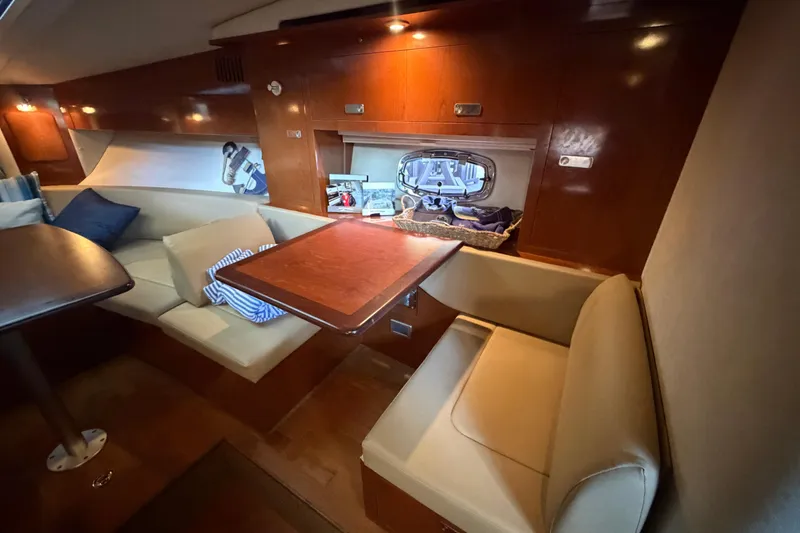 Slide: The Image of Luxurious interior of 2012 Sea Ray Sundancer 310 yacht with cozy seating and wooden finishes. - 25