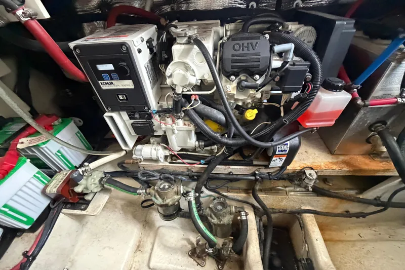 Slide: The Image of Engine compartment of a 2012 Sea Ray Sundancer 310, featuring a Kohler generator and battery setup. - 32