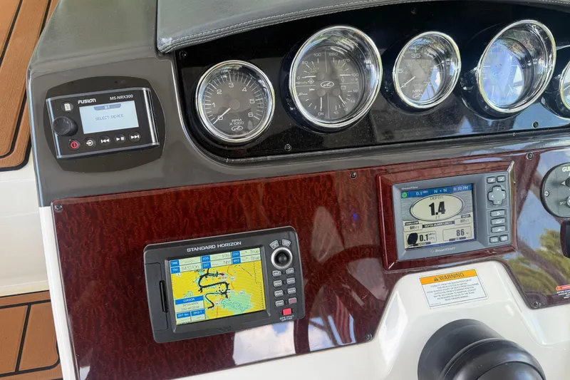 Slide: The Image of Dashboard of a 2012 Sea Ray Sundancer 310 with navigation and control instruments. - 15