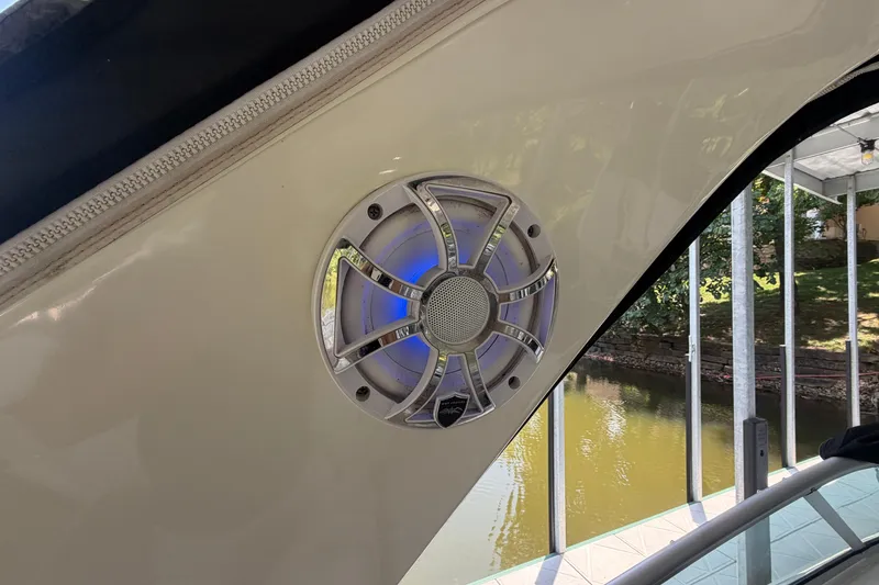Slide: The Image of Speaker on 2012 Sea Ray Sundancer 310 boat, docked by a serene waterway. - 19
