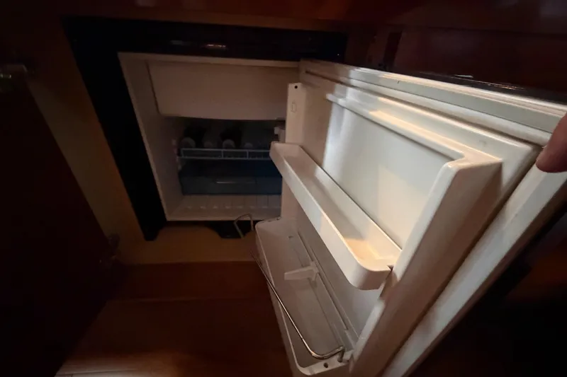Slide: The Image of Open refrigerator inside a 2012 Sea Ray Sundancer 310 yacht cabin. - 27