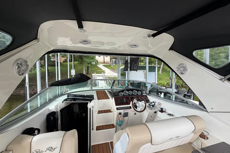 Slide: The Image of Interior view of 2012 Sea Ray Sundancer 310 boat, featuring helm and seating area. - 18