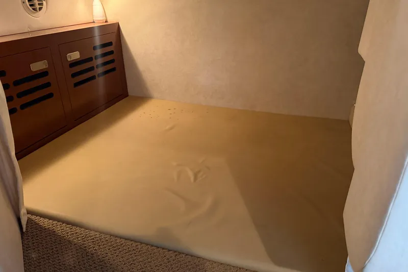 Slide: The Image of Interior cabin of 2012 Sea Ray Sundancer 310 with wooden storage and beige flooring. - 30