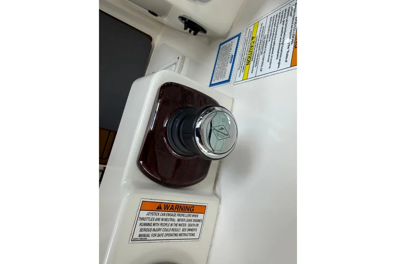 Slide: The Image of 2012 Sea Ray Sundancer 310 joystick control with warning labels. - 16