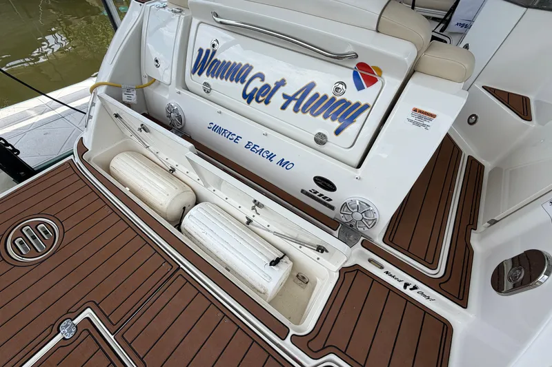 Slide: The Image of 2012 Sea Ray Sundancer 310 boat deck with storage and custom lettering. - 6