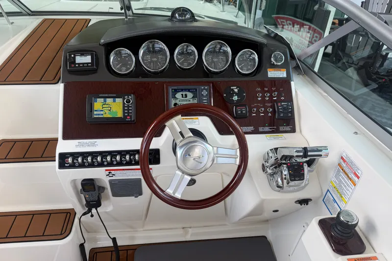 Slide: The Image of 2012 Sea Ray Sundancer 310 helm with gauges, GPS, and controls. - 14
