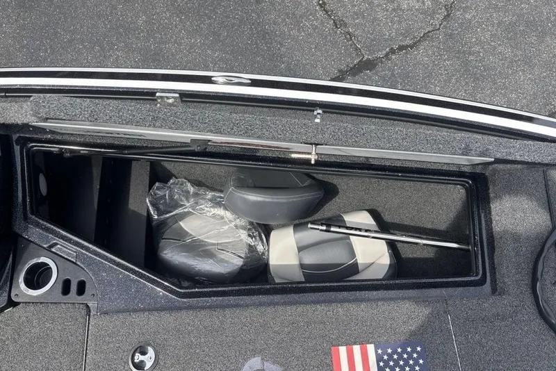 Slide: The Image of Storage compartment of a 2018 Nitro Z19 Pro boat with seats and an American flag decal. - 13