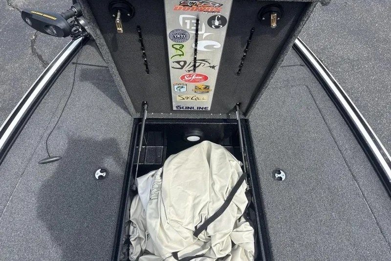 Slide: The Image of Open storage compartment of a 2018 Nitro Z19 Pro boat with various stickers. - 7