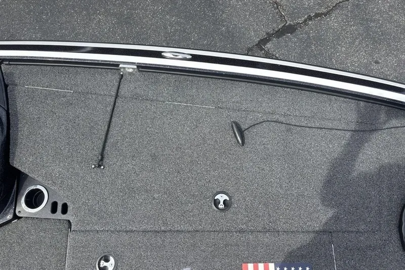 Slide: The Image of 2018 Nitro Z19 Pro boat deck with carpet, rod holder, and American flag detail. - 10
