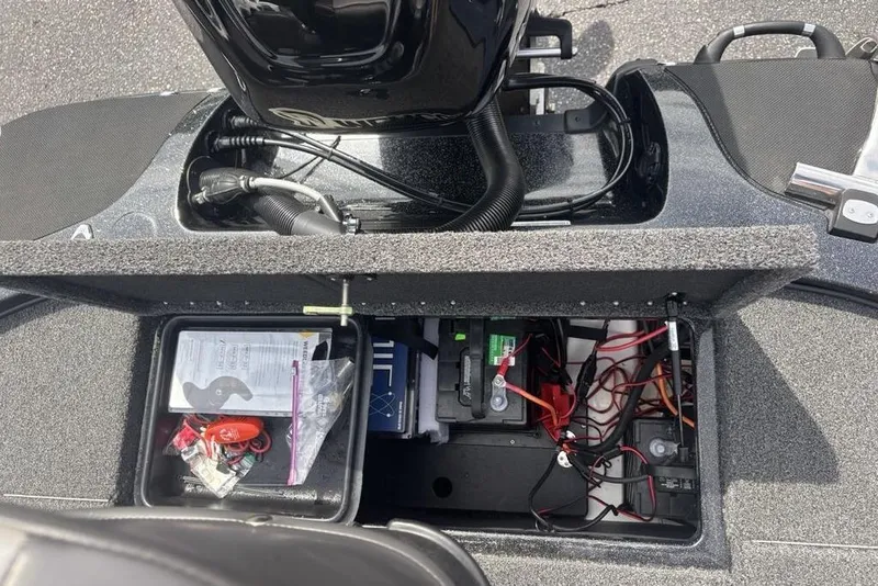 Slide: The Image of 2018 Nitro Z19 Pro boat storage compartment with battery and wiring. - 31