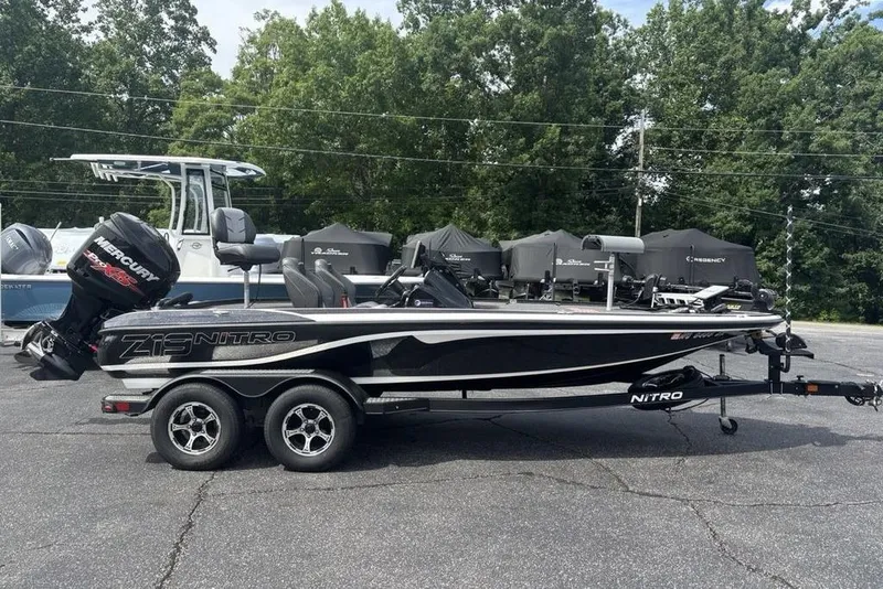 The Image of 2018 Nitro Z19 Pro boat with Mercury engine on trailer, parked outdoors. - 1
