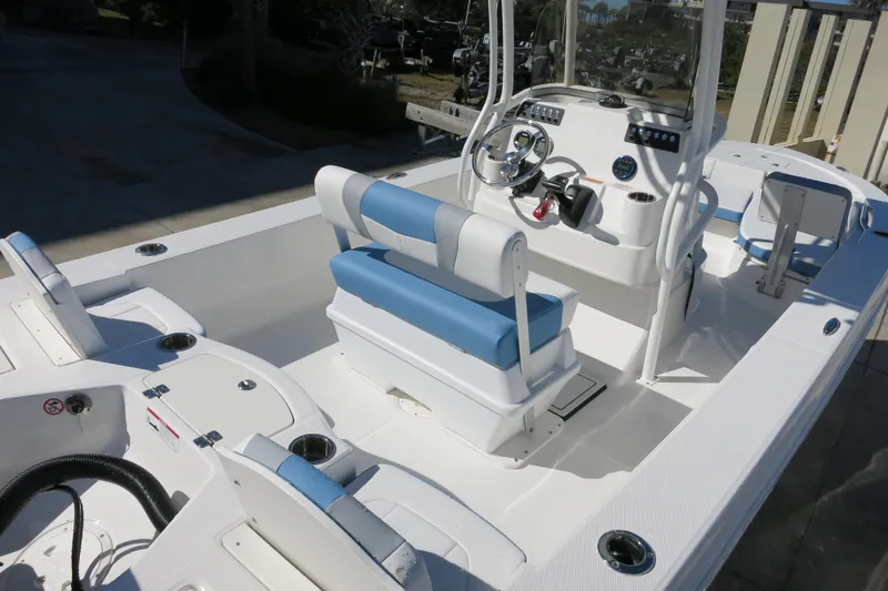 Slide: The Image of 2026 Robalo 206 Cayman boat interior with blue and white seating, steering console, and spacious deck. - 7