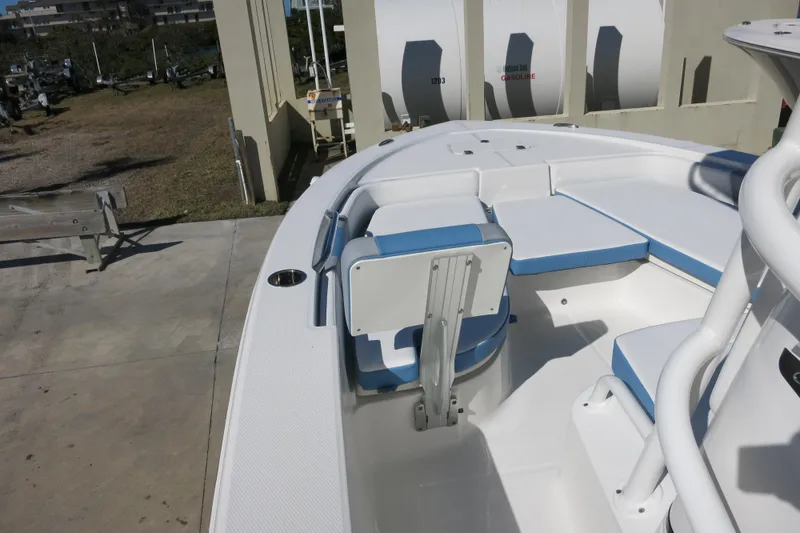 Slide: The Image of 2026 Robalo 206 Cayman boat interior with blue and white seating, docked outdoors. - 14