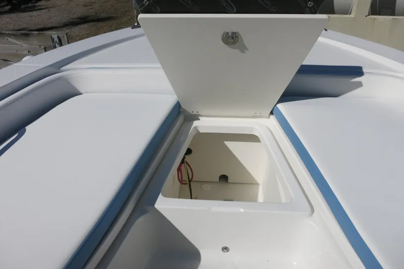 Slide: The Image of Open storage compartment on 2026 Robalo 206 Cayman boat, featuring cushioned seating. - 18
