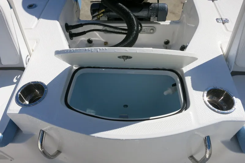Slide: The Image of Livewell compartment on 2026 Robalo 206 Cayman boat, featuring cup holders and storage. - 9