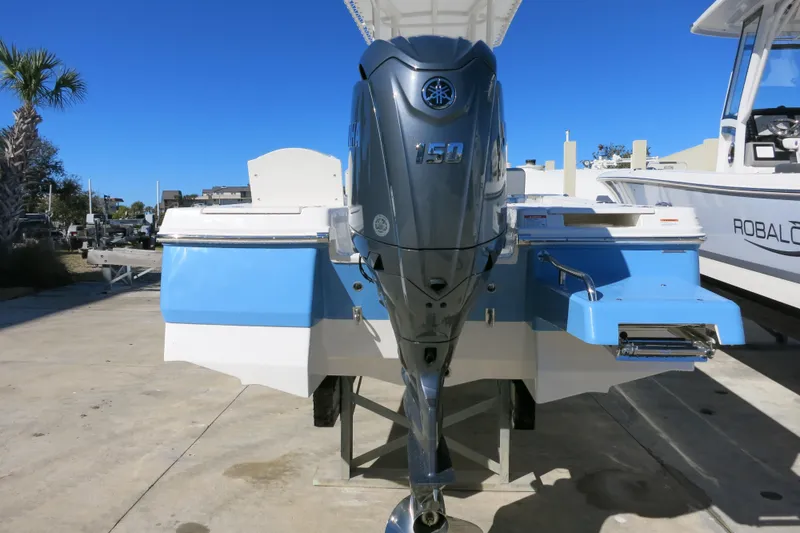 Slide: The Image of 2026 Robalo 206 Cayman boat with Yamaha 150 engine, docked outdoors. - 6