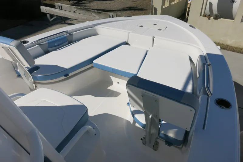 Slide: The Image of 2026 Robalo 206 Cayman boat interior with white and blue seating arrangement. - 13