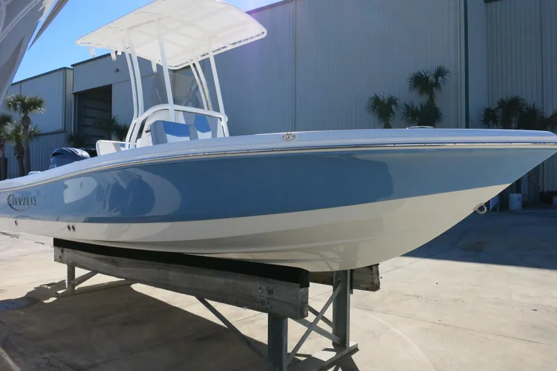 Slide: The Image of 2026 Robalo 206 Cayman boat displayed outdoors on a stand, featuring sleek design and white hull. - 5