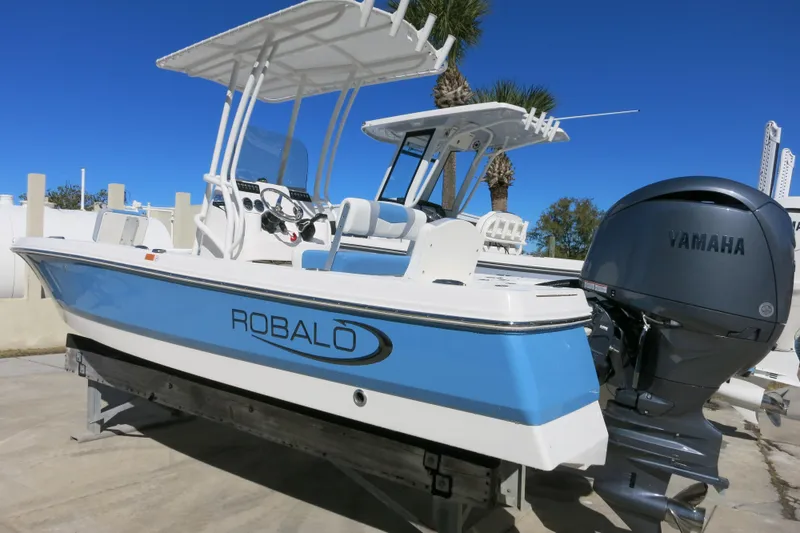 Slide: The Image of 2026 Robalo 206 Cayman boat with Yamaha engine, displayed outdoors on a sunny day. - 2